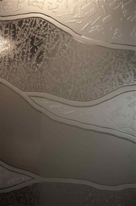 etched glass carved sandblasted glass wall divider Close up showing more details featured in the various textgures.