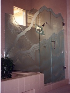 etched decorative glass shower enclosure abstract waves chiseled edges "Rugged Retreat" gives the illusion of multi-layers with waves crossing over one another. Note the "matching mirror" inside the shower, the edges are chiseled and waves are etched and 3-dimenssionally sculpture carved.