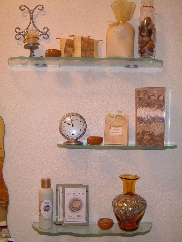 Bathroom shelves, glass with chiseled irregular edges, installed over commode.