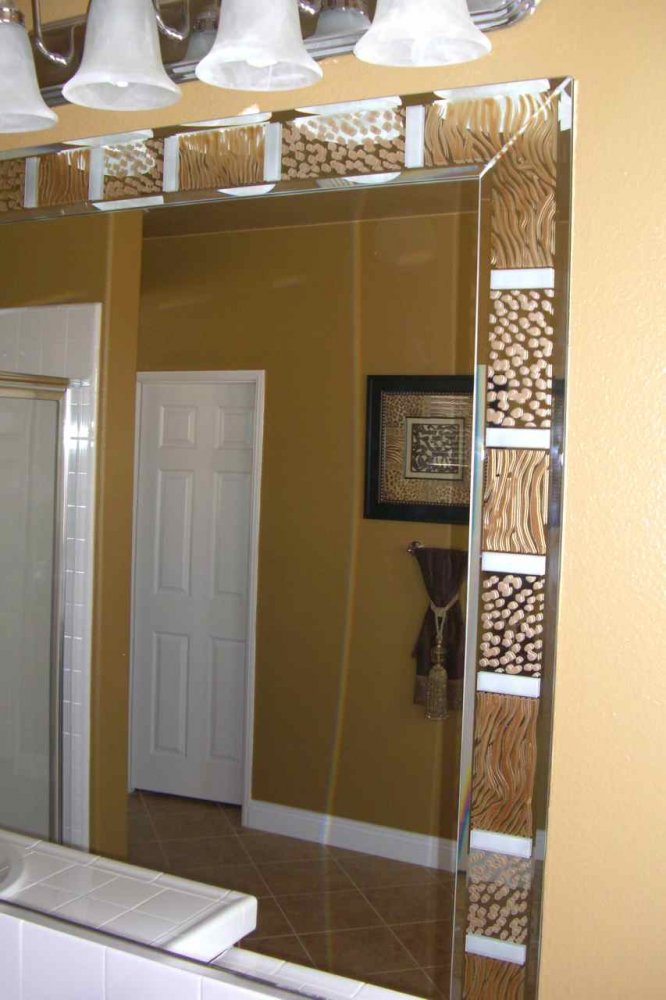 Custom beveled mirror strips, overlay pieces on the mirror border that have been etched, carved and painted in animal print motif.