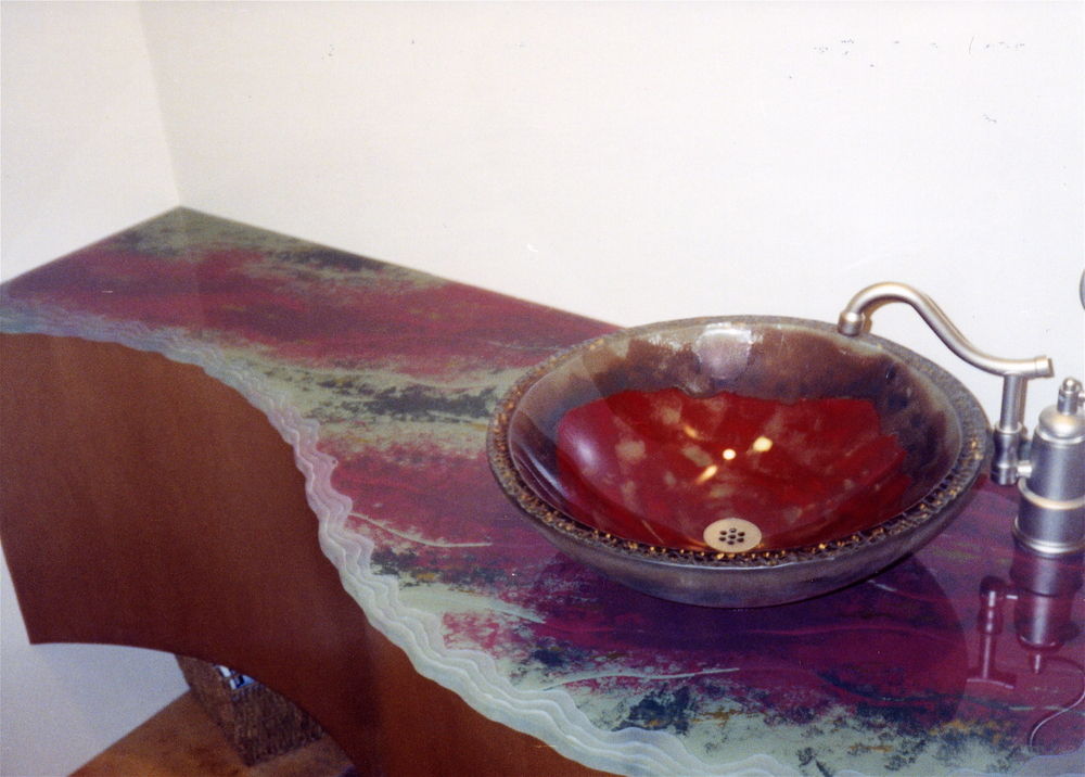 Decorative glass bath vanity top. Etched, carved and painted glass with a Shoreline Edge on the top surface.