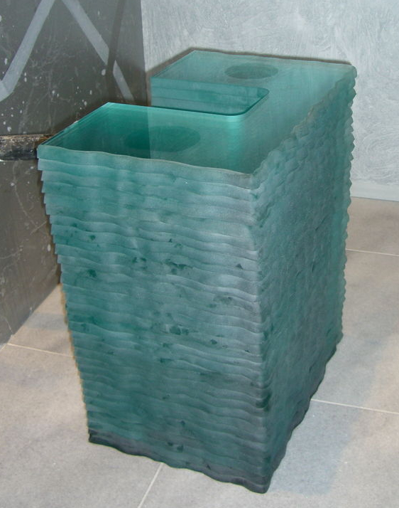 bathroom vanity glass layers A view of the vanity glass base, as it was being assembled. Each layer is 3/4" thick, regular clear glass. The thicker the glass, the greener the hue. When glass is layered, even more so.